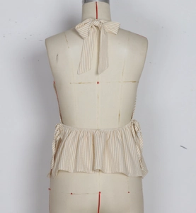 Detail of the back tie closure and ruffled hem on the striped halter neck top