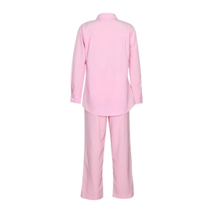 Back view of pink linen casual suit featuring button-up shirt and wide-leg trousers