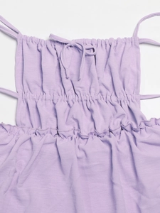 Detailed close-up of lavender drawstring dress with ruffle trim and knit texture