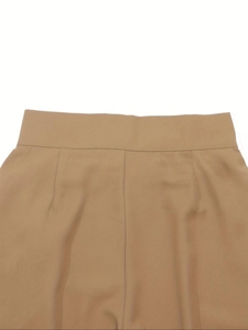 Detailed macro view of high-waist wide-leg trousers showing khaki twill fabric and stitching