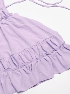 Detailed close-up of lavender tiered ruffles and slim ties on a summer dress