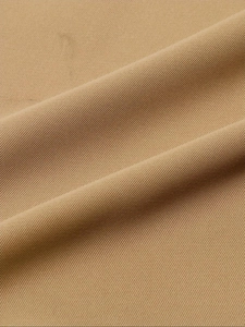 Close-up of premium khaki twill fabric texture with high-density diagonal weave patterns