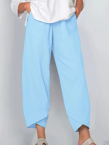 Detail of light blue wide-leg pants featuring elastic waist and unique petal-shaped cuffs