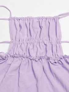 Detail of lavender smocked dress with elastic gathering and thin shoulder straps