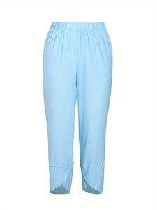 Detail of light blue cropped wide-leg pants featuring a unique cross petal cut at the hem