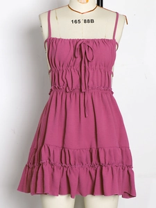 Detail of tiered magenta summer dress with drawstring neckline and ruffled elastic waist