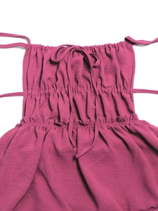 Detail of fuchsia backless dress showing elastic shirring and thin shoulder ties