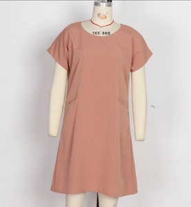 Detail view of pink loose fit summer dress with round neck and side pockets