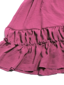 Detail of rose pink dress with ruffled hem and premium micro-wrinkle fabric texture