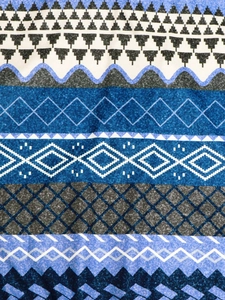 Detailed macro view of vintage geometric floral print fabric on a women's jacket