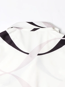 Detail shot of white casual shirt neckline with abstract black and purple wavy patterns