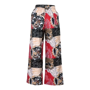 Detail of high-waisted elastic waistband on wide-leg trousers with leopard floral print
