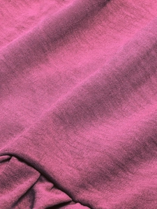 Close-up of high-quality rose pink woven fabric texture with fine cross-weave detail