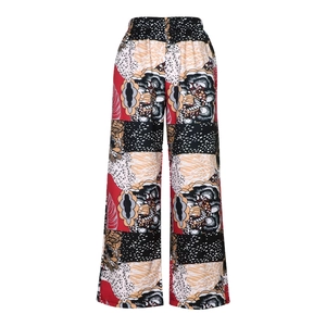 Close-up of bohemian high-waisted wide-leg pants with vintage geometric floral prints