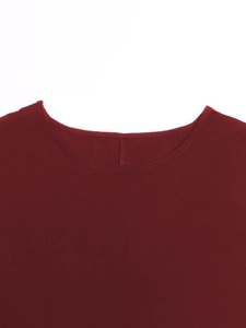 Detailed macro view of the round neckline and soft cotton linen texture of the wine red dress