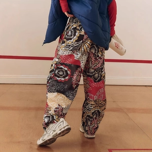 Detail of bohemian floral wide-leg pants with elastic waist and vibrant multi-color print