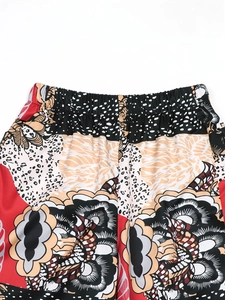 Close-up of elastic waistband on 3D leopard print trousers with floral and wave patterns