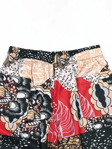 Detail of high-waist leopard print pants featuring elastic band and back pockets