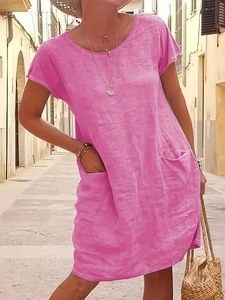 Detail of loose pink cotton linen dress with practical side pocket and summer texture