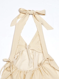 Detail of yellow and white striped halter top featuring tie-up neck and ruched sides