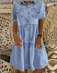 Detail view of light blue denim tiered dress with short sleeves and button-down collar