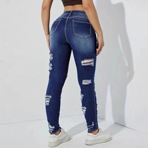 Detailed back view of dark blue high waist skinny jeans with distressed ripped denim details