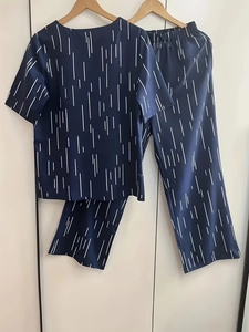 Detail of navy blue lounge set featuring vertical white stripe pattern and relaxed fit