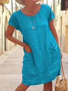 Close-up of lightweight cotton linen dress showing front pockets and round neckline detail
