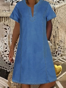 Detail of V-neckline and contrast yellow stitching on navy blue denim midi dress