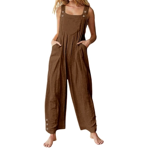 Detail of loose dark brown cotton linen overalls with wide straps and button accents