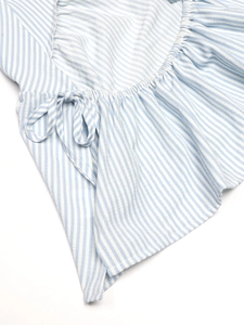 Close-up of blue and white striped summer top with ruffle edges and cute ribbon bow detail
