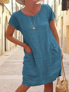 Close-up of blue cotton linen dress with practical side pockets and natural texture