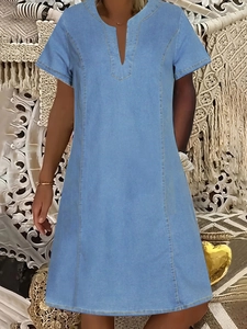 Detail of yellow double-needle stitching on light blue denim V-neck dress for women