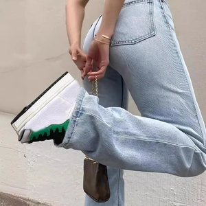 Detailed view of high-waist light blue straight jeans with classic denim texture and rear pockets
