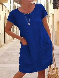 Detail of royal blue linen dress featuring practical front pockets and a casual fit