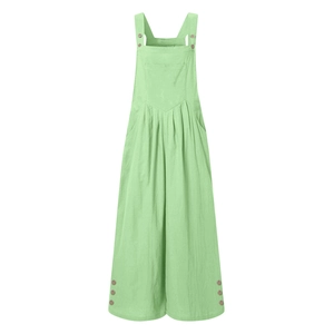 Detail of light green overall pants with wooden buttons and decorative chest pocket