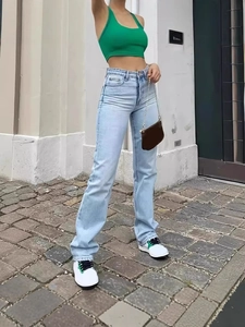 Women's light blue high-waisted straight-leg jeans shown in a stylish street style pose