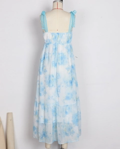 Detail of the blue floral maxi dress featuring light blue lace straps and layered hemline