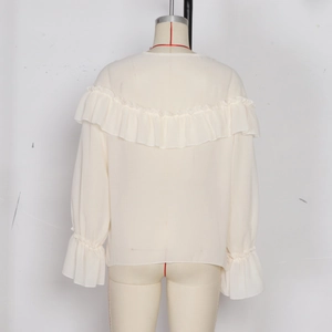 Detail view of the elegant tiered ruffle trim on the back of this beige chiffon blouse