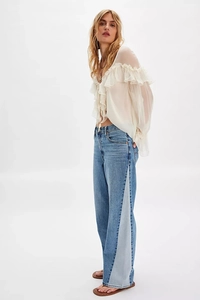 Detail of elegant chiffon blouse featuring ruffle trim and flowing bohemian style design