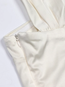 Detail of invisible zipper on ivory satin halter crop top with pleated silk texture