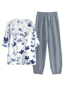 Women's two-piece casual set featuring floral print white top and grey-blue loose trousers