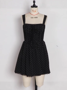 Black polka dot mini dress with lace trim and spaghetti straps on a mannequin display