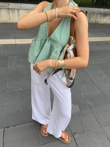 Women's green checkered halter top and white wide-leg trousers casual summer outfit