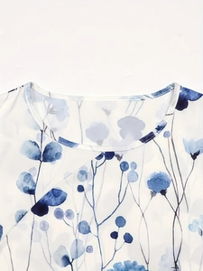 Close-up of the round neckline showing blue floral print detail on white fabric