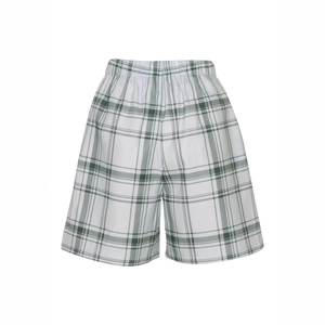 Detail of high-waist plaid shorts featuring green checkers and elastic waistband texture