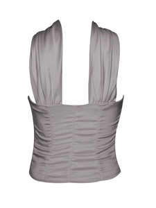 Detail view of the gray ruched back and tailored waist of a slim fit halter top