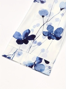 Detail shot of the sleeve showing blue floral ink print on white polyester fabric