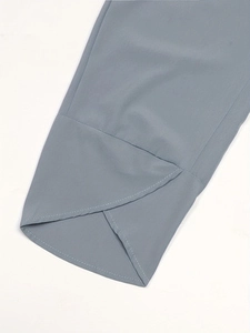 Detail of tulip-style overlapping hem on blue-grey floral casual two-piece pants set