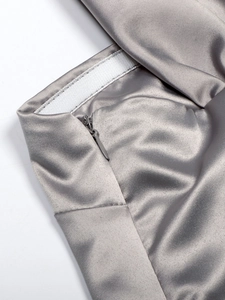 Close-up of invisible zipper and stitching on grey satin tube top with silky finish
